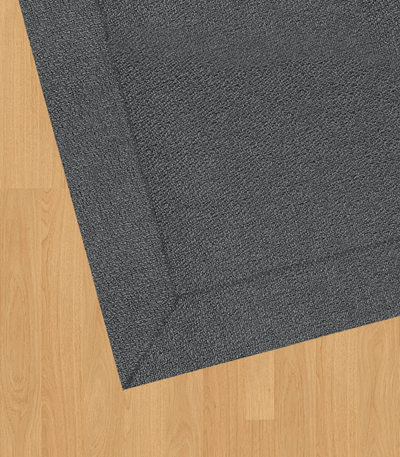 Alfombra vinilo tejido premium para interior y exterior en suelo de madera.